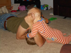 He tackled Daddy and held him down to kiss him.