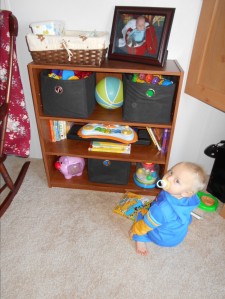 How Tru's toy shelf looks out in our family room. We did away with the toy box and this works out much better. 